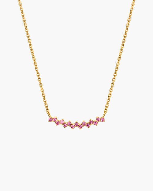 Collar Aria en rosa, barra curva en tono dorado con una fila de piedras redondas rosas, en cadena de eslabones